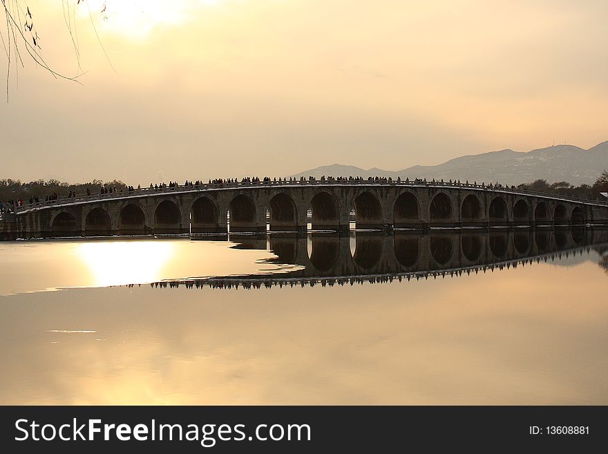 The Summer Palace in Beijing is the largest imperial garden in the world with a history of over 800 years. The seventeen-arch bridge (the longested stone bridge in Summber Palace) in winter sunset. The Summer Palace in Beijing is the largest imperial garden in the world with a history of over 800 years. The seventeen-arch bridge (the longested stone bridge in Summber Palace) in winter sunset.