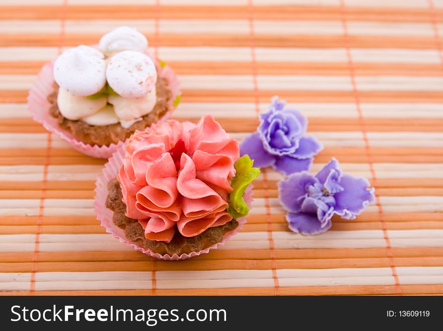 Cupcakes on the orange napkins and flowers. Cupcakes on the orange napkins and flowers