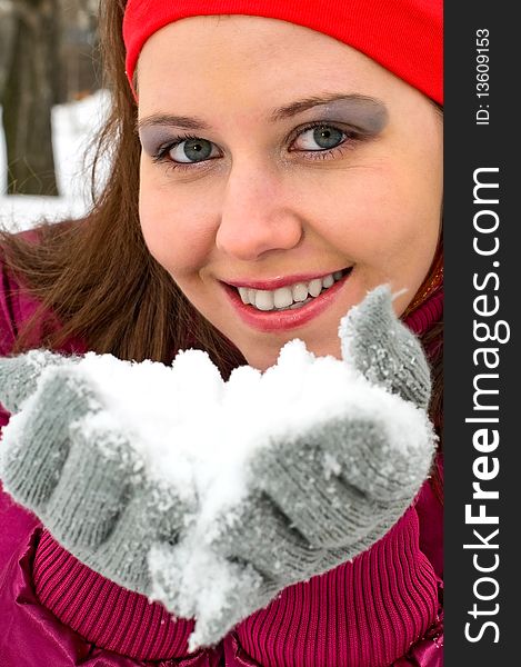 Portrait of young smiling woman blowing snow. Portrait of young smiling woman blowing snow