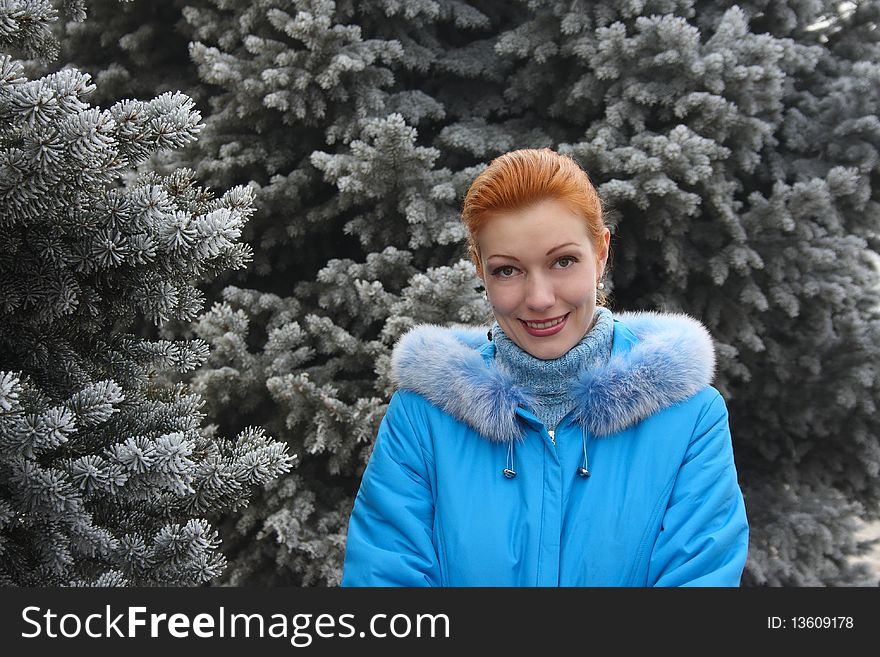 The red-haired girl against the frozen fur-trees. The red-haired girl against the frozen fur-trees