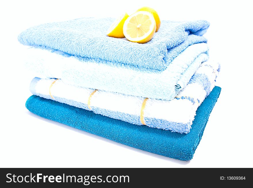 Fresh towels with lemon isolated on white