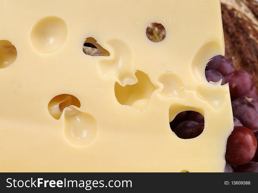 Close up with cheese and red grapes isolated