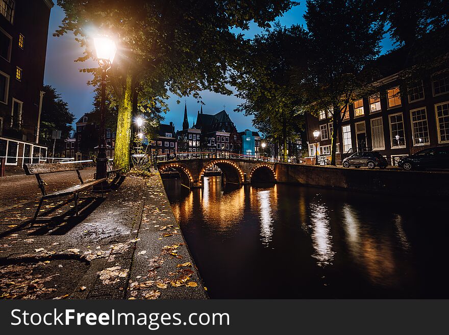 Tranquil scene of Amsterdam, autumn cityscape of beautiful bridge over canal. the Netherlands. Long exposure.