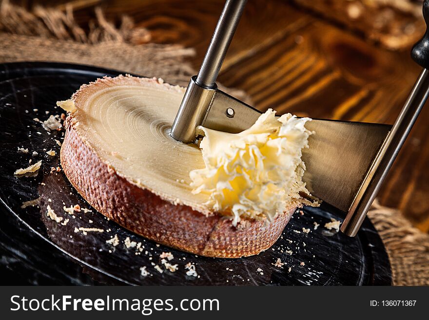 Shaving Of Tete De Moine Cheese On A Girolle. Close Up View. Copy Space For Text, Logo Or Brand.