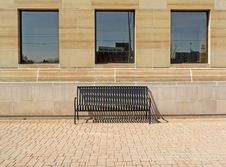 Solitary Bench Under Three Windows Royalty Free Stock Image