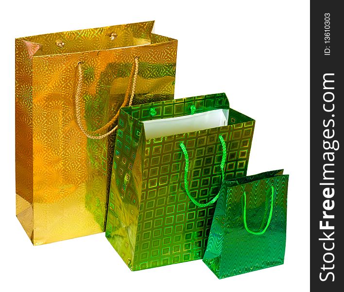 Present bags isolated on white background. Yellow and green packets.