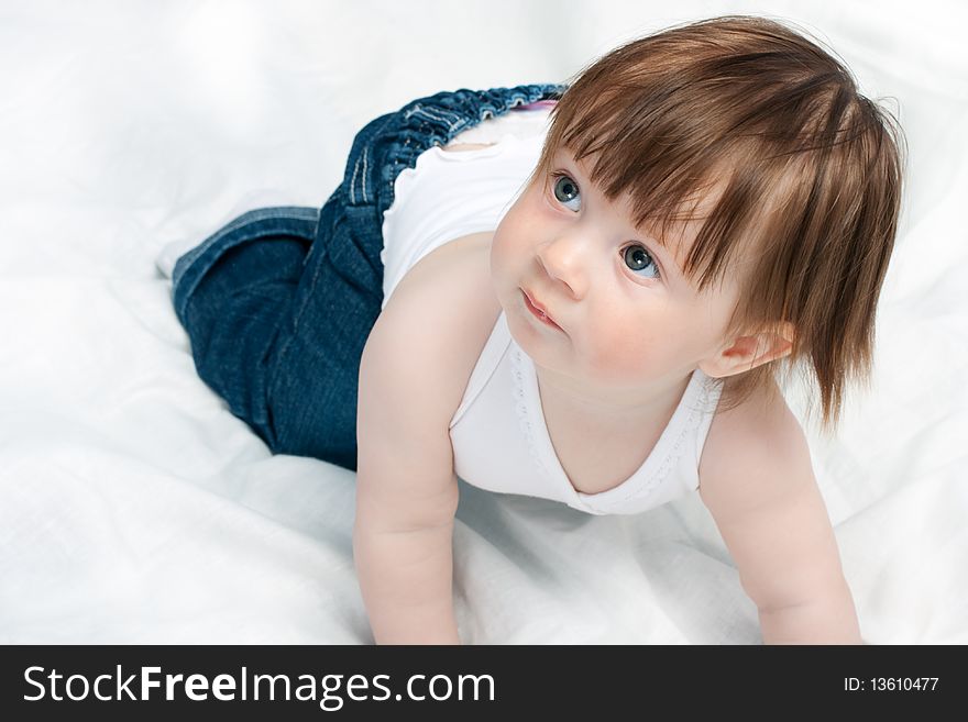 Little baby girl playing on the bed. Little baby girl playing on the bed