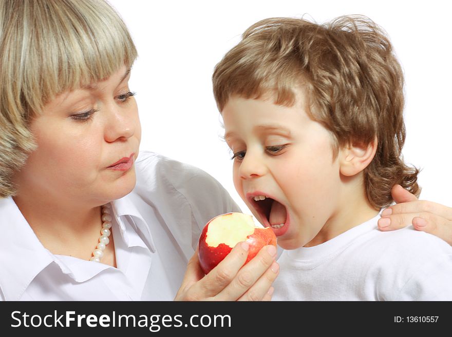 Woman and little boy playing and eating an apple. Woman and little boy playing and eating an apple