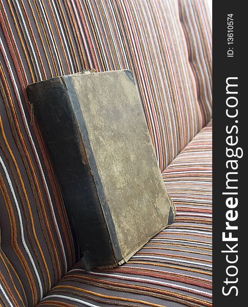 Antique book on the striped bed. Antique book on the striped bed.