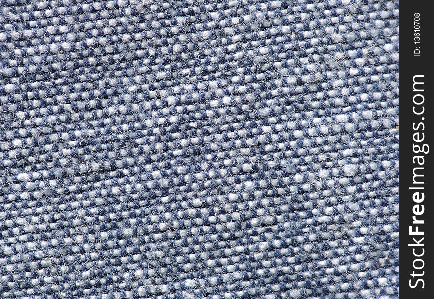 Closeup detail of the texture in a piece of blue fabric or cloth. Closeup detail of the texture in a piece of blue fabric or cloth.