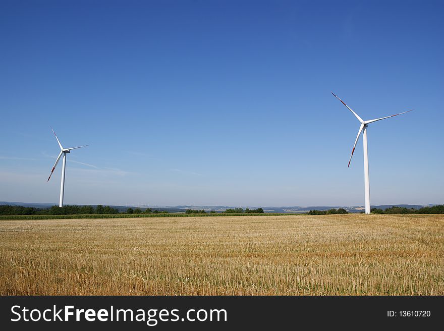 Power generating wind turbines in the countryside. Lot of copy space. Power generating wind turbines in the countryside. Lot of copy space.