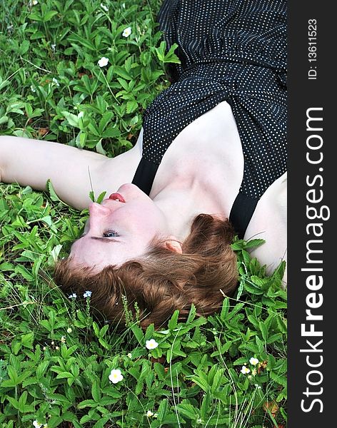 Young woman lie on summer green lown. Young woman lie on summer green lown