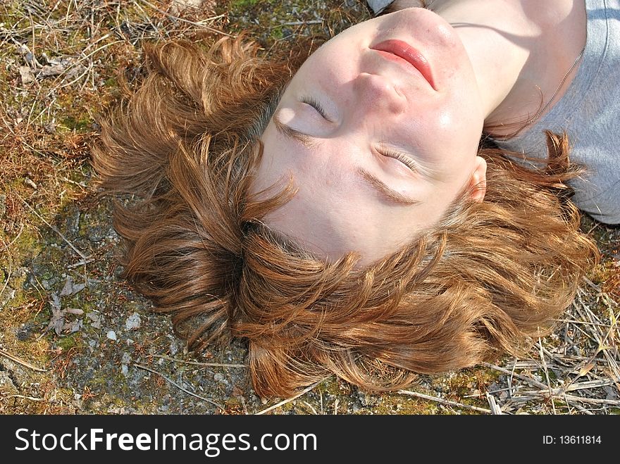 Young woman lie on summer moss lawn