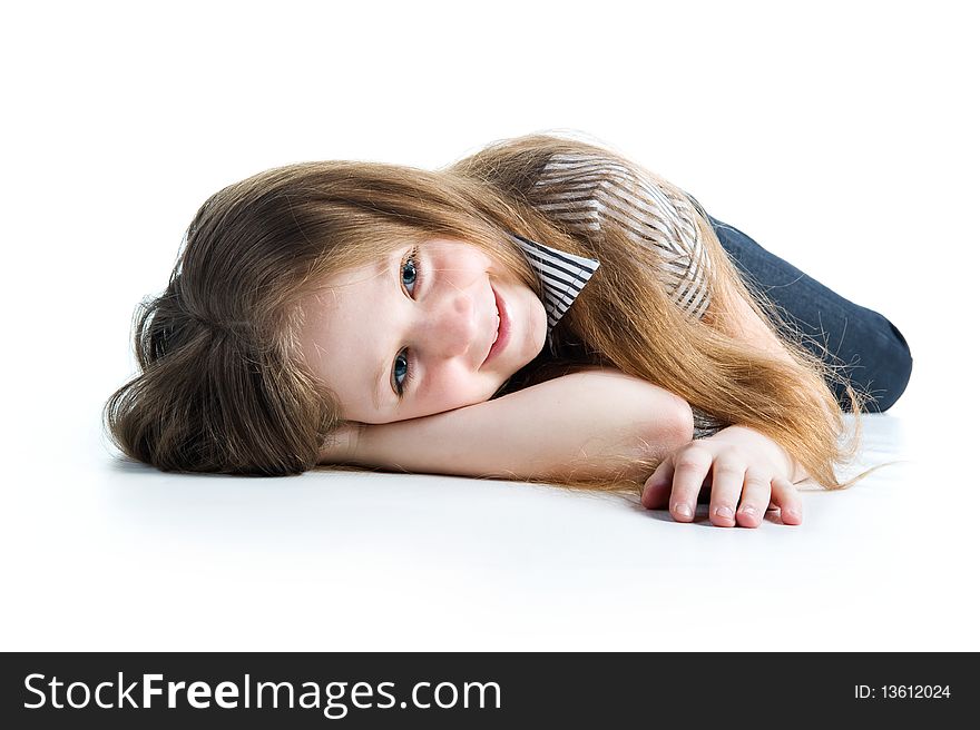 Beautiful little girl lie. Isolated on a white background