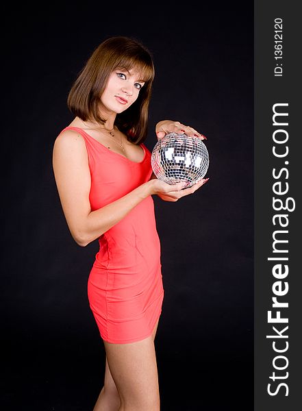 Girl with discoball on a black background