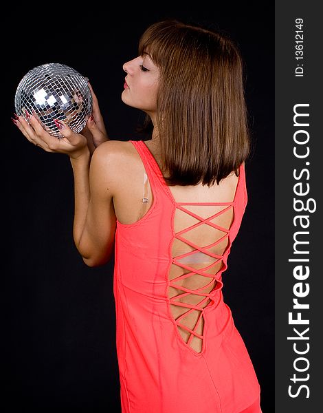 Girl with discoball on a black background