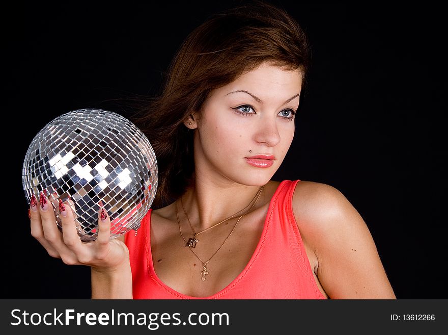 Girl with discoball on a black background