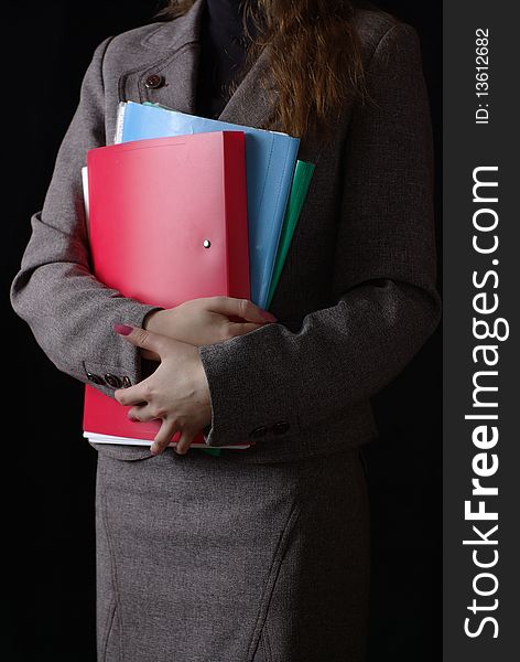 Business woman and folders on black background