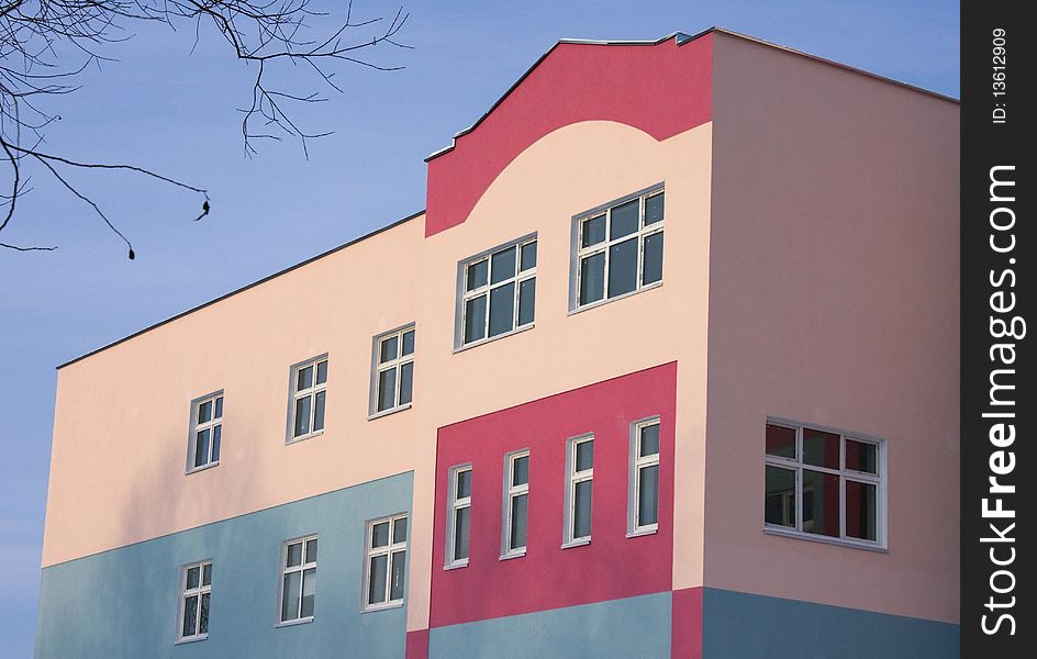 A brightly colored building in city.