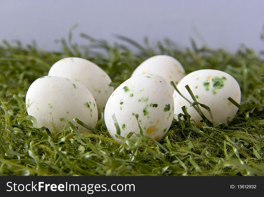 Four Colored Easter Eggs Lying on Green Grass