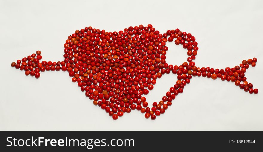 Two hearts with an arrow composed of seeds of red sandalwood