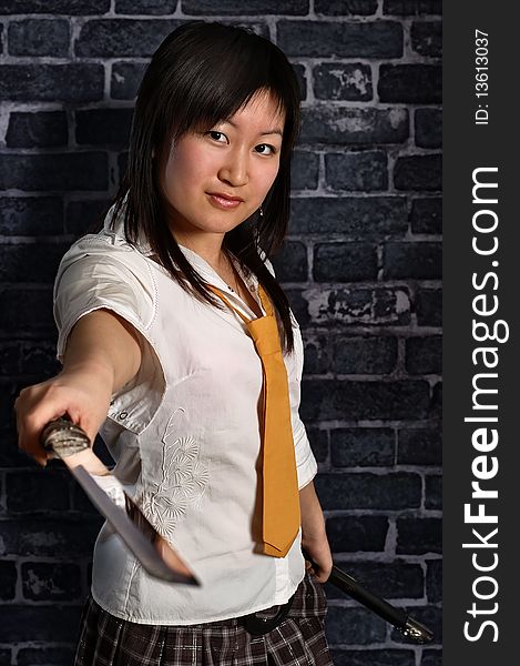 Beautiful japan schoolgirl with katana in her hand. Beautiful japan schoolgirl with katana in her hand