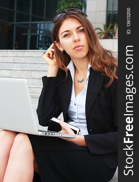 Business woman sitting on stairs with laptop. Business woman sitting on stairs with laptop