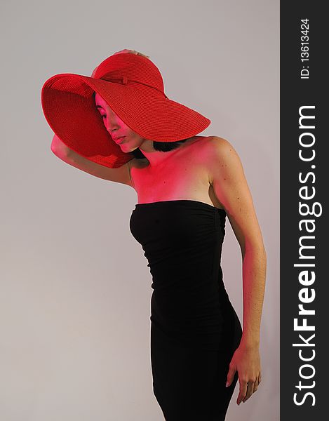 Portrait of young stylish woman on black dress wearing a hat. Portrait of young stylish woman on black dress wearing a hat