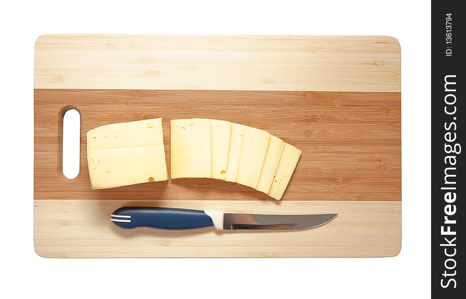 Chef's knife hopping an cheese on an wooden cutting board - white background.