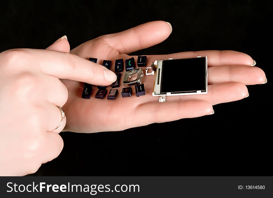 Mobil telephone in women  hands with  black background