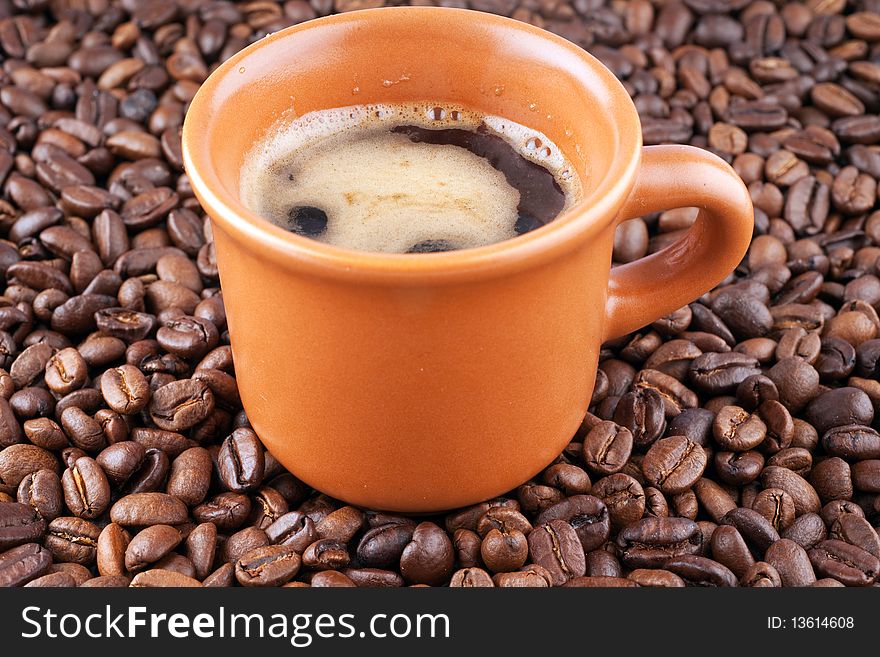 Cup of coffee on a background of coffee grains.