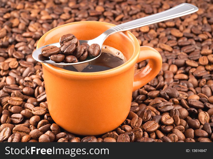 Cup of coffee on a background of coffee grains.