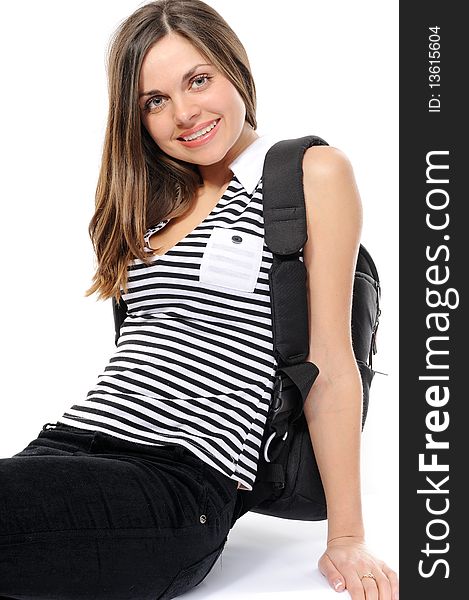 Pretty young female student with a backpack, smiles, On a white background