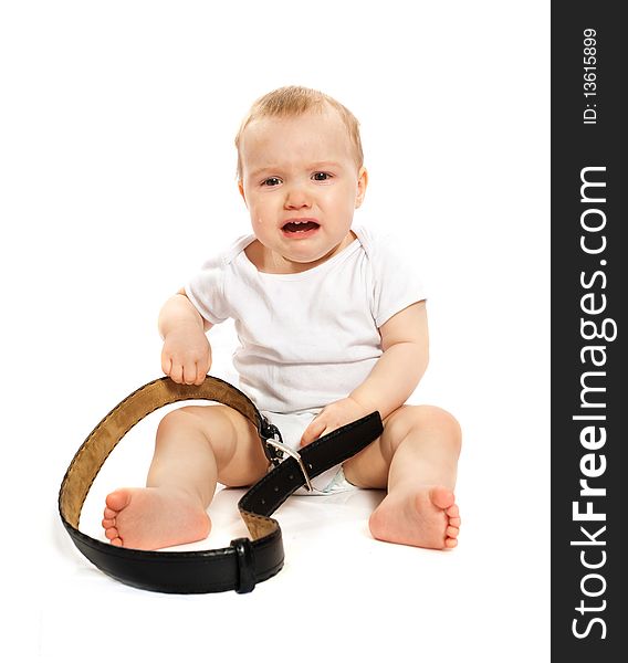 Unhappy 1-year old baby with a belt