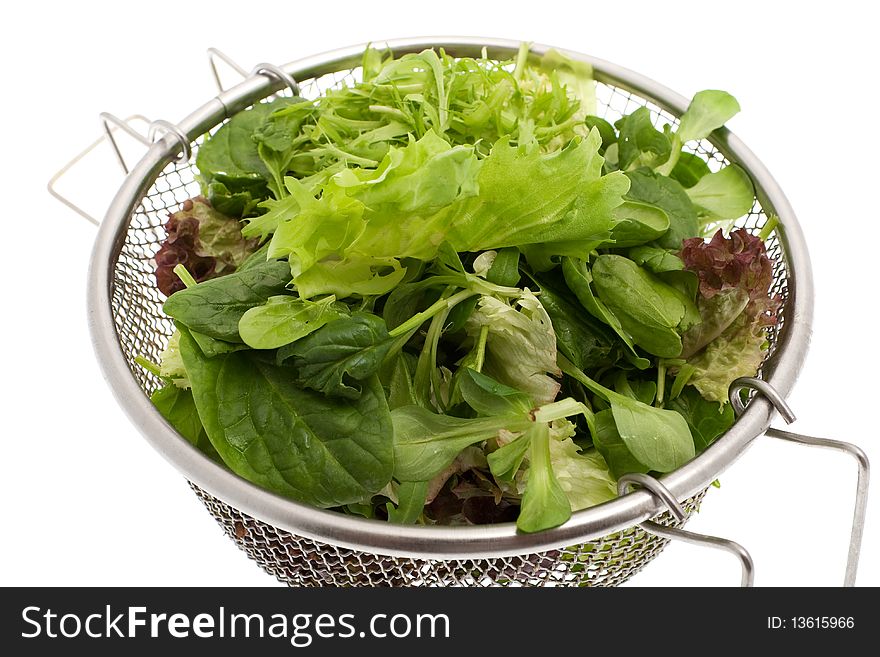 Green salad, different kinds of garden salad in a sieve