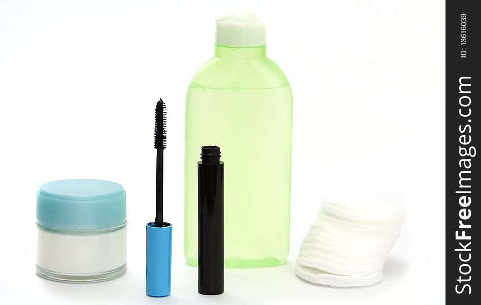 A lotion, a cream, ink for eyelashes, wadded disks on a white background. A lotion, a cream, ink for eyelashes, wadded disks on a white background