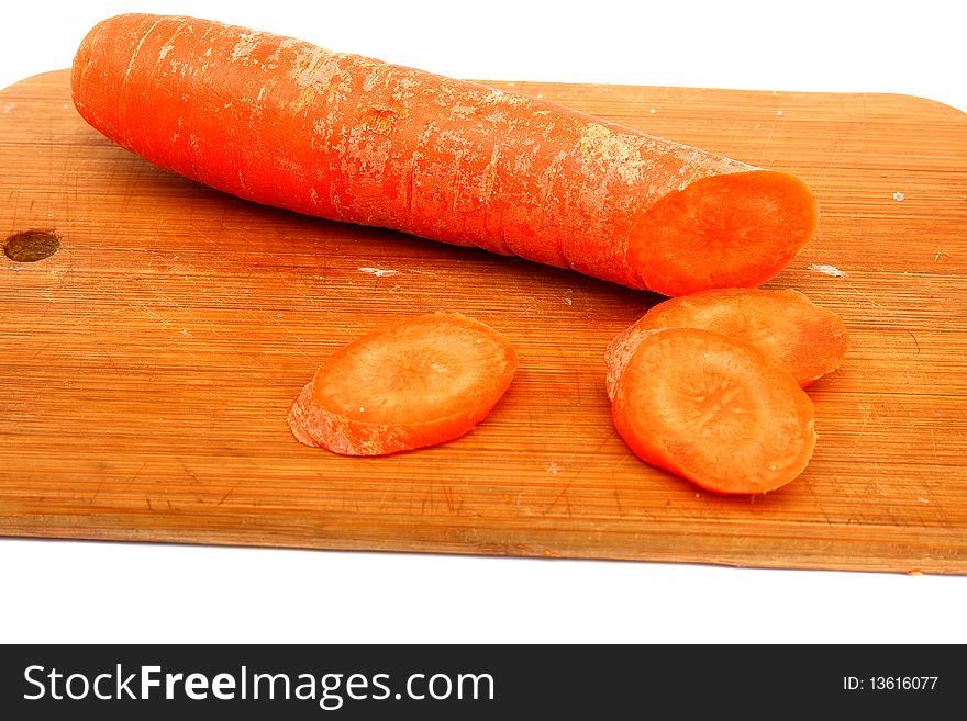 The orange carrot on a cutting board