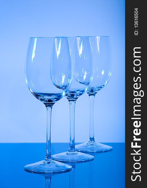 Empty wineglasses used blue light for lightning before background