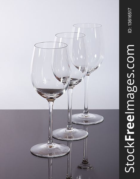 Empty wineglasses before a white background.