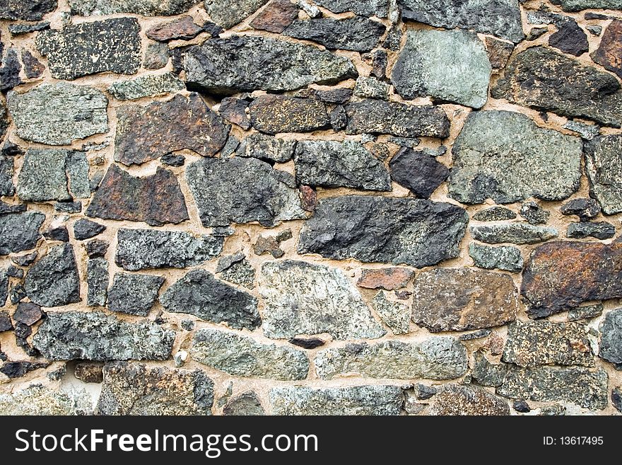 Medieval wall brick texture or background made of stones and rocks. Part of wall of a medievial church in Poland.