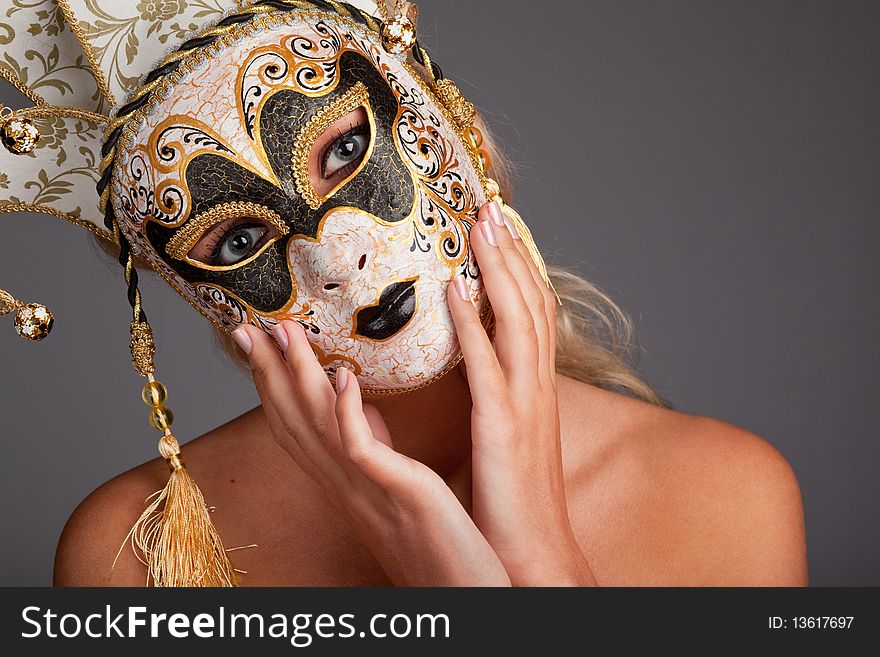 Portrait of beautiful young woman wearing carnival mask