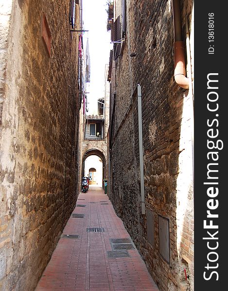 Narrow street in San Giminiano fortress, Tuscany, Italy