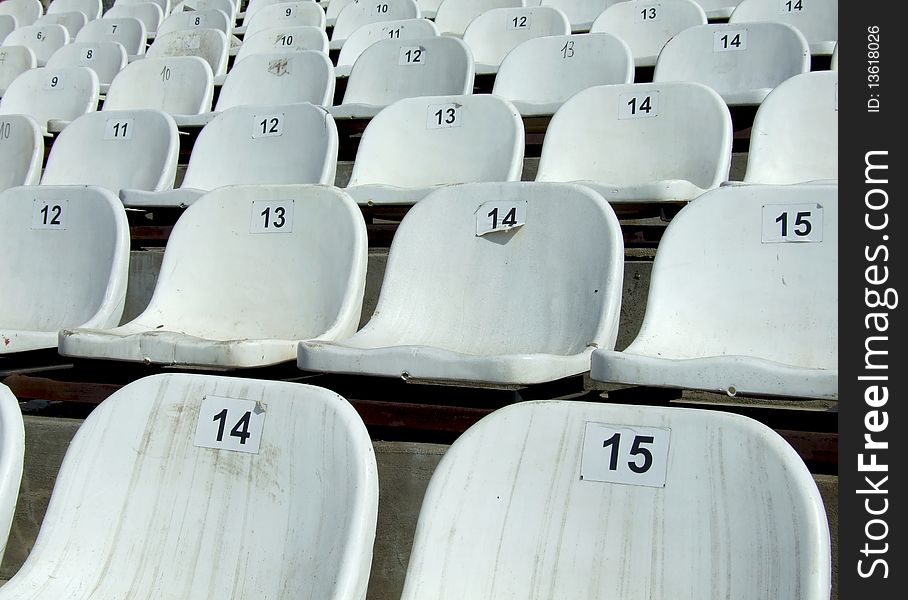 Some dirty chairs on a stadium