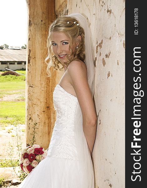 Beautiful Blond bride wearing diamond jewelery and a white gown
