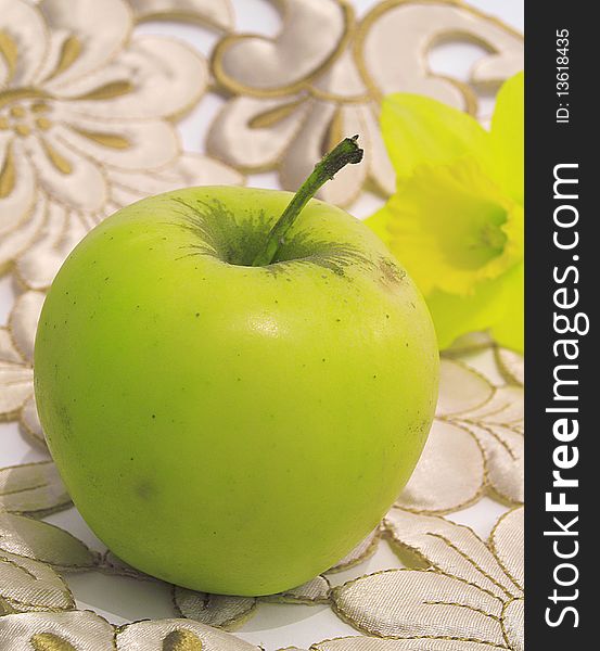 Fresh,green,healthy apple and flower behind,on floral background