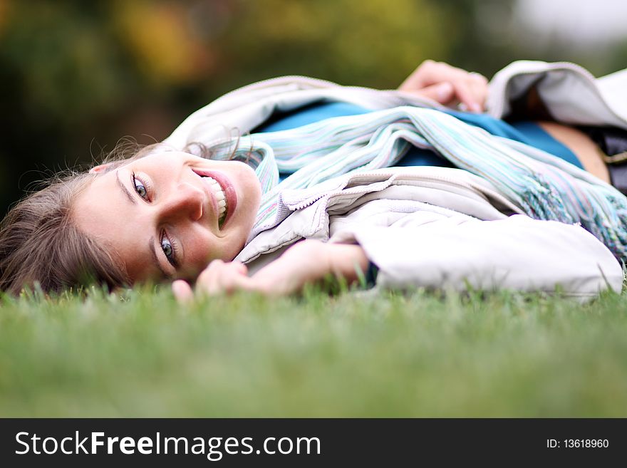 Beautiful young woman relaxing in the grass