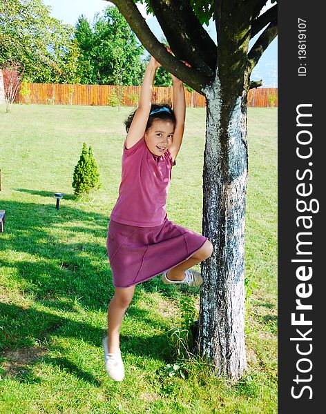 Girl climbing tree and playing