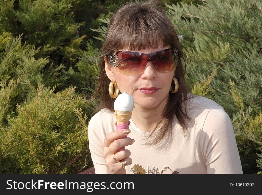 Portrait of young happy woman eating ice-cream, outdoor. Portrait of young happy woman eating ice-cream, outdoor