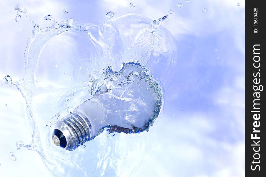 Light bulb in blue water. Technology background