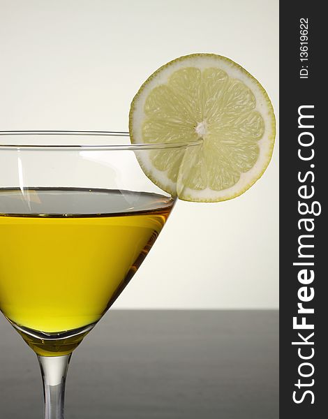 Photo of a lemon drop martini garnished with a lemon slice.